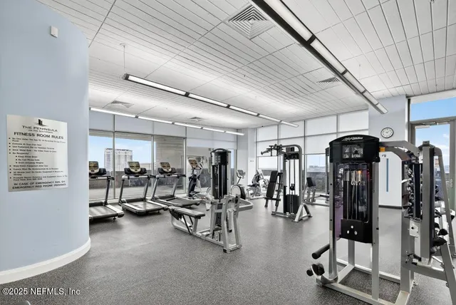 a kitchen with stainless steel appliances granite countertop a table chairs and a wooden floor