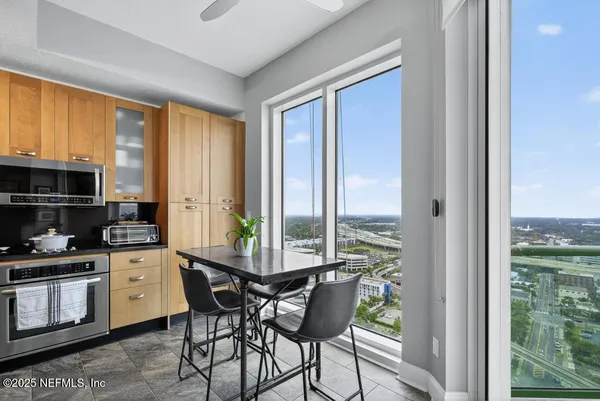 a view of a dining room with furniture window and wooden floor