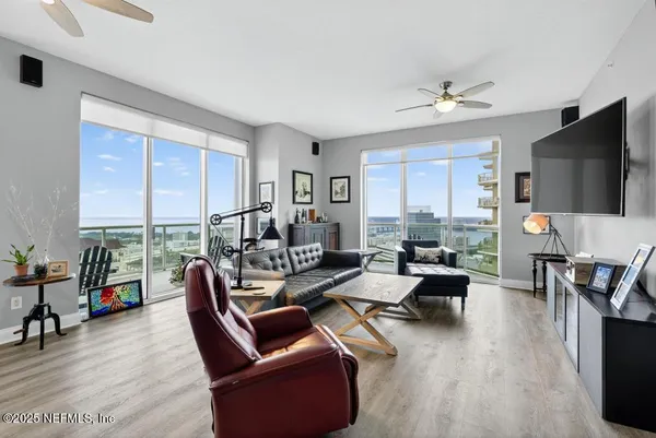 a living room with furniture and a chandelier