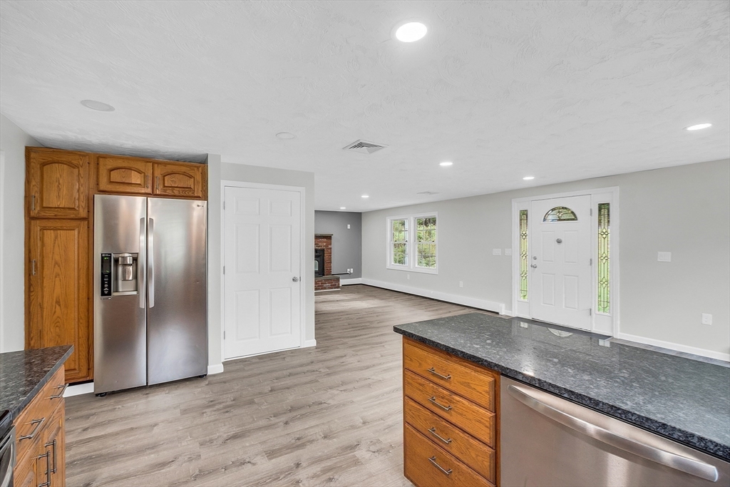 59 Molasses Hill Road Brookfield, MA 01506 - Photo 11 of 42 a view of a refrigerator in kitchen and wooden floor