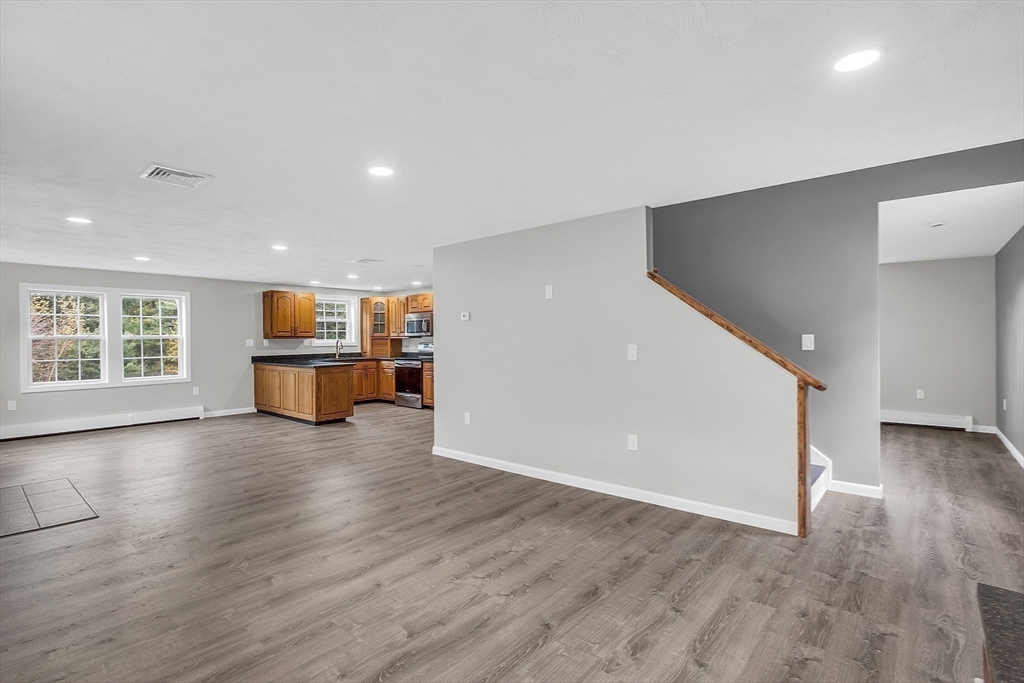 59 Molasses Hill Road Brookfield, MA 01506 - Photo 12 of 42 a view of empty room with wooden floor and windows