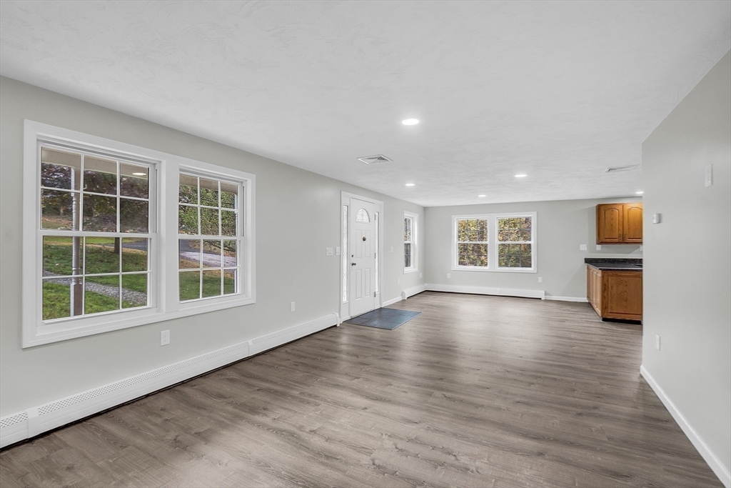59 Molasses Hill Road Brookfield, MA 01506 - Photo 13 of 42 a view of empty room with wooden floor and windows
