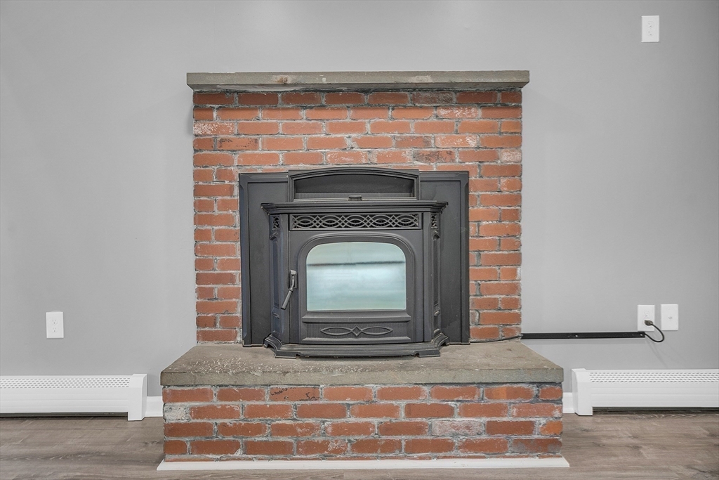 59 Molasses Hill Road Brookfield, MA 01506 - Photo 15 of 42 a view of fireplace and wooden floor