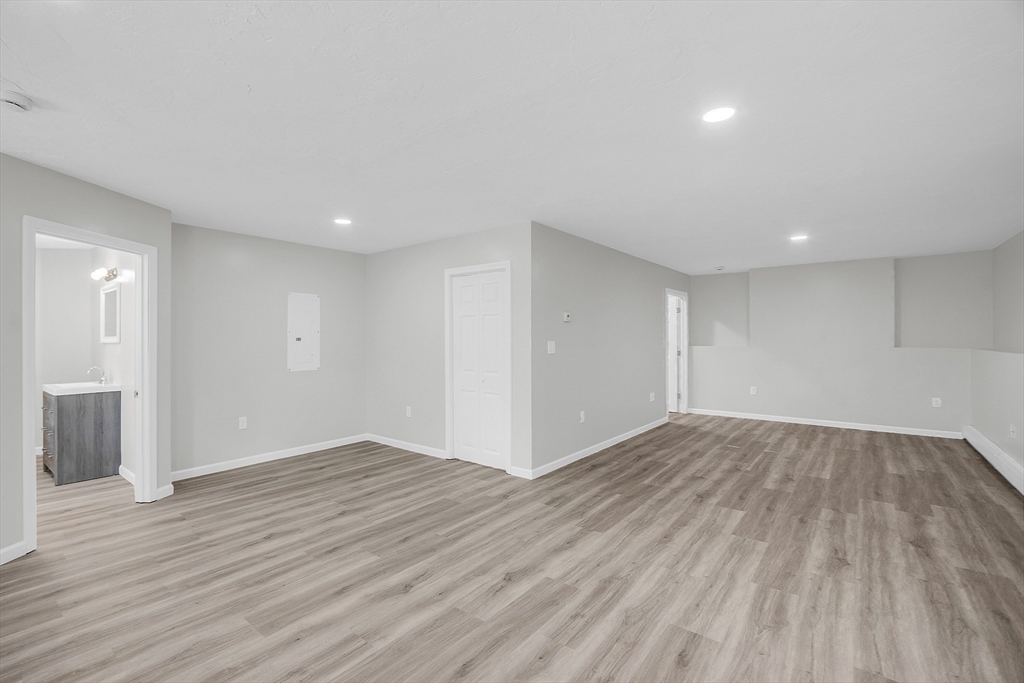 59 Molasses Hill Road Brookfield, MA 01506 - Photo 17 of 42 a view of an empty room with wooden floor and a window