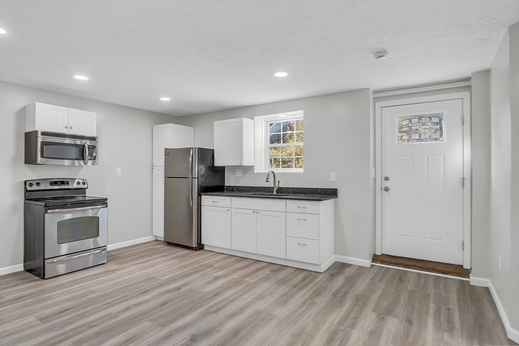 59 Molasses Hill Road Brookfield, MA 01506 - Photo 18 of 42 a kitchen with granite countertop a refrigerator stove and oven