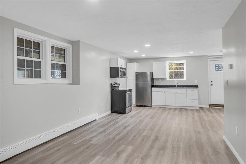 59 Molasses Hill Road Brookfield, MA 01506 - Photo 21 of 42 a view of a kitchen with wooden floor and a sink