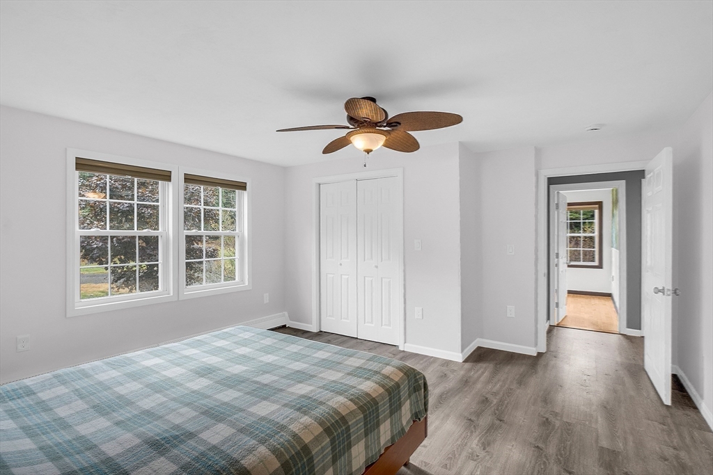 59 Molasses Hill Road Brookfield, MA 01506 - Photo 27 of 42 a bedroom with a bed and a chandelier