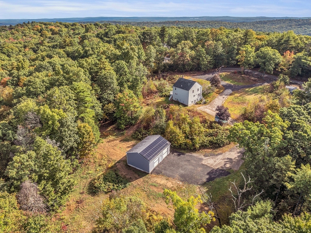 59 Molasses Hill Road Brookfield, MA 01506 - Photo 4 of 42 a wooden bench sitting in the middle of a yard