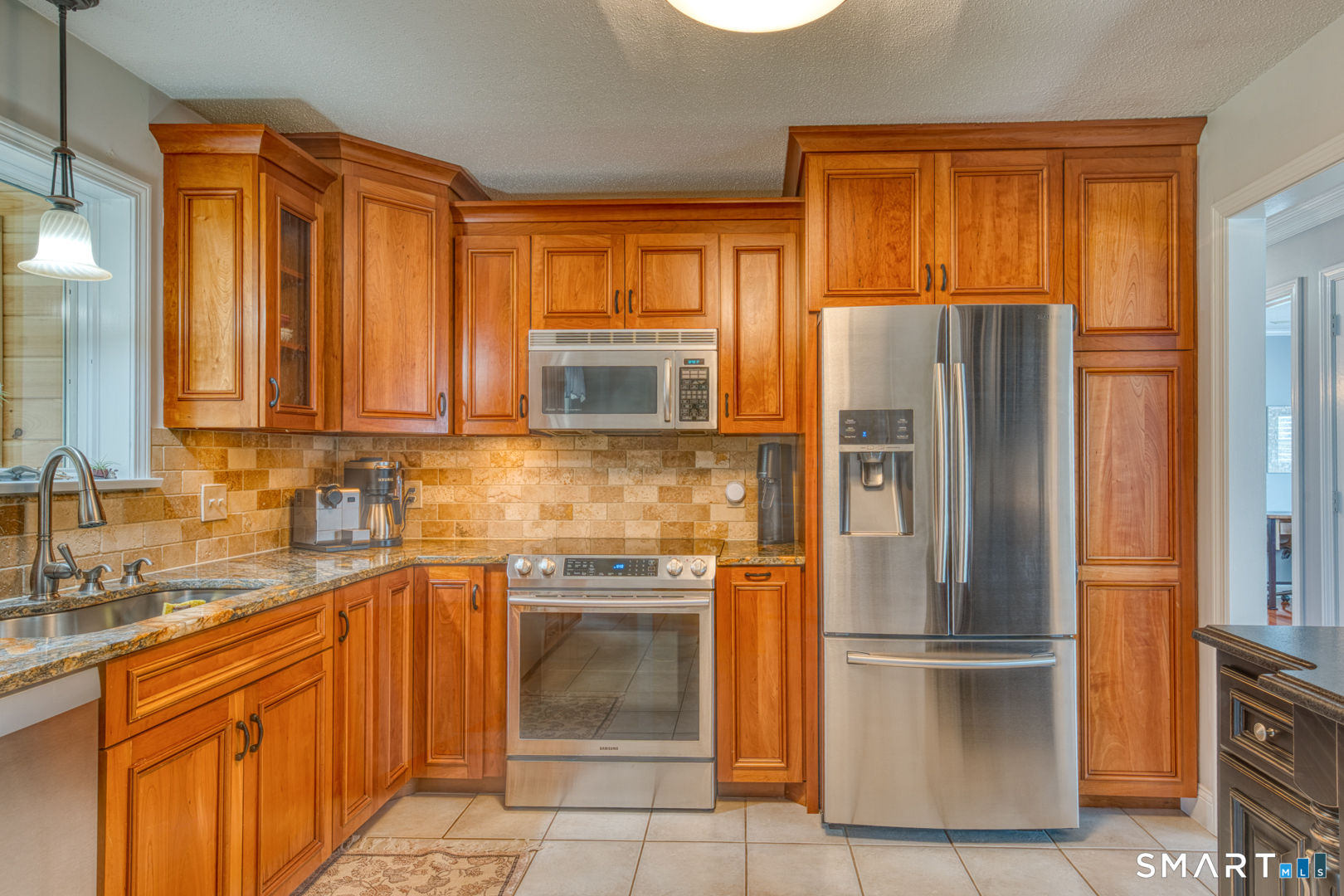 11 Hally Lane Colchester, CT 06415 - Photo 10 of 36 Beautiful cherry cabinets and high-end granite counters...custom tile backsplash.