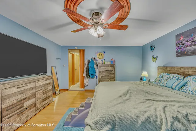 a bedroom with a bed and a chandelier