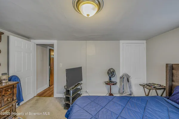 a bedroom with furniture and a window