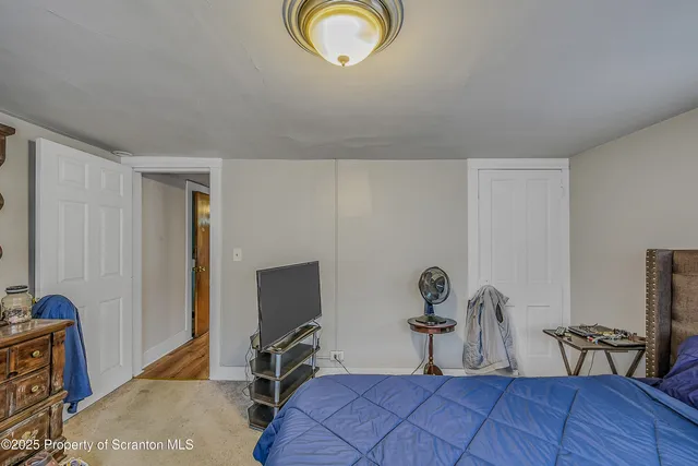 a bedroom with furniture and a window