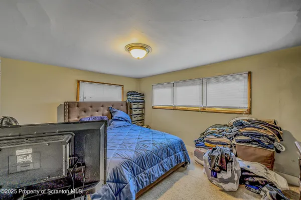 a bedroom with a bed and a table