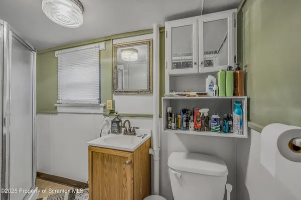 a bathroom with a toilet a sink and a mirror