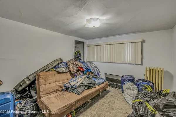 a bedroom with furniture and a book shelf