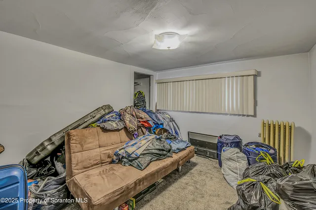 a bedroom with furniture and a book shelf