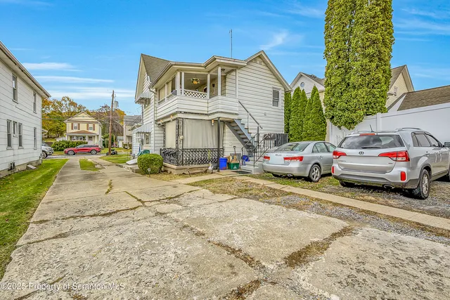 a view of a cars park in front of a building