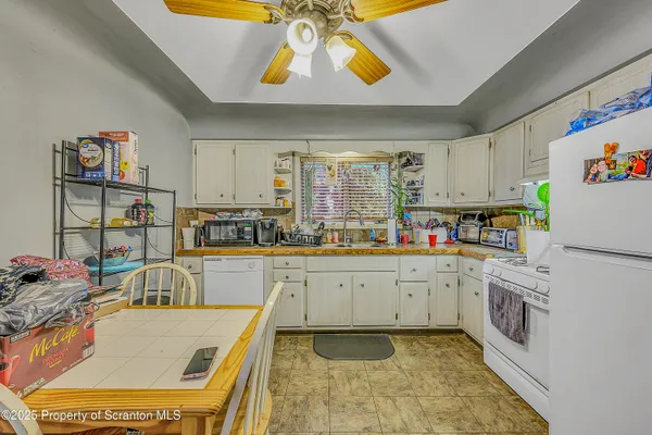 a kitchen with stainless steel appliances granite countertop a sink and cabinets