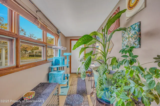 a vase with flowers sitting on a table in front of a window