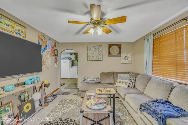 a living room with furniture and painting on the wall