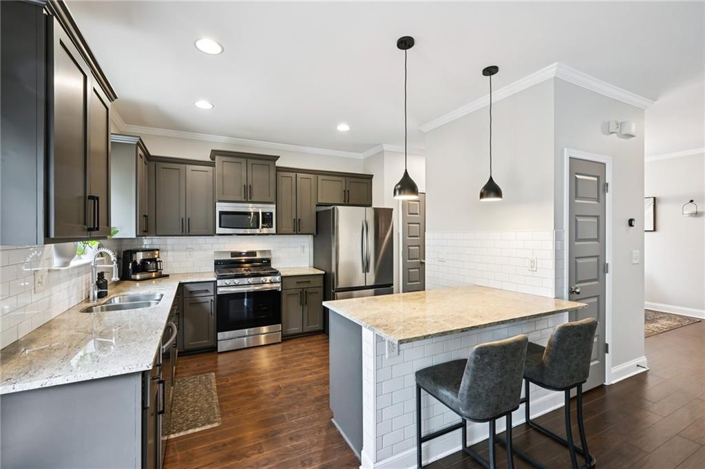 2358 Boulder Road Southeast Atlanta, GA 30316 - Photo 8 of 28 a kitchen with granite countertop a sink appliances and wooden floor