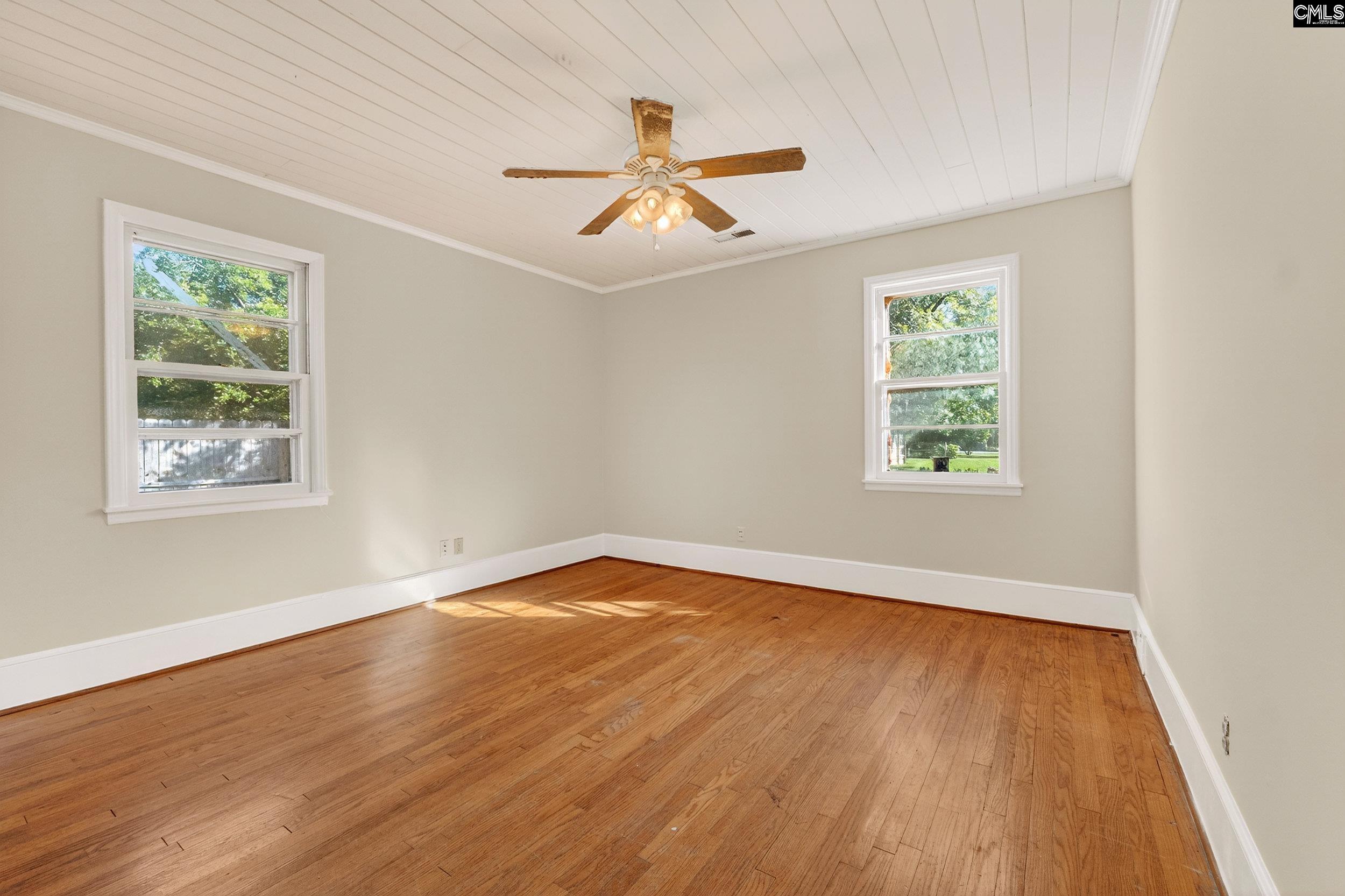 729 Magnolia Street Pelion, SC 29123 - Photo 10 of 32 wooden floor in an empty room with a window