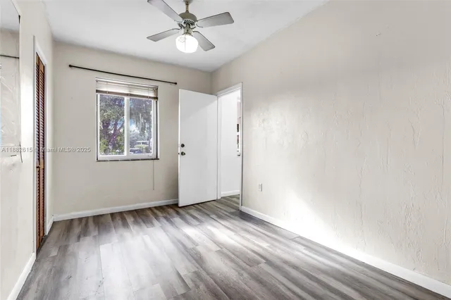 a view of a room with wooden floor