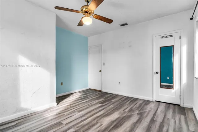 a bedroom with a bed and glass door