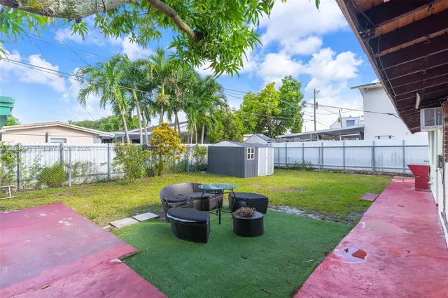 an aerial view of residential houses with outdoor space and street view