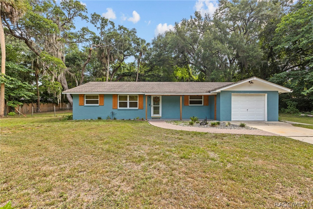 107 Allen Avenue Inglis, FL 34449 - Photo 32 of 36 a front view of a house with a garden