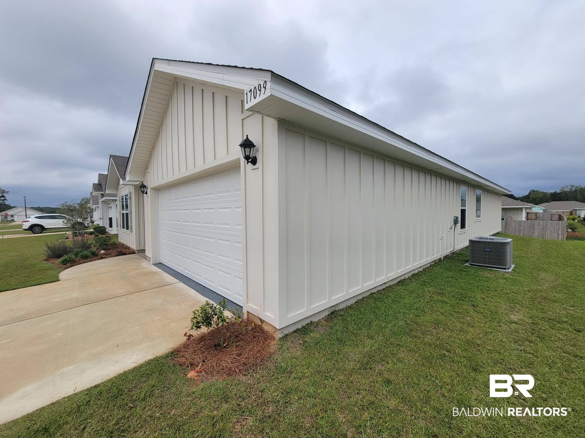 17099 REFLECTION Street Loxley, AL 36551 - Photo 4 of 29 View of property exterior with central AC unit, a garage, and a yard