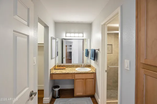 a bathroom with a granite countertop toilet and a shower