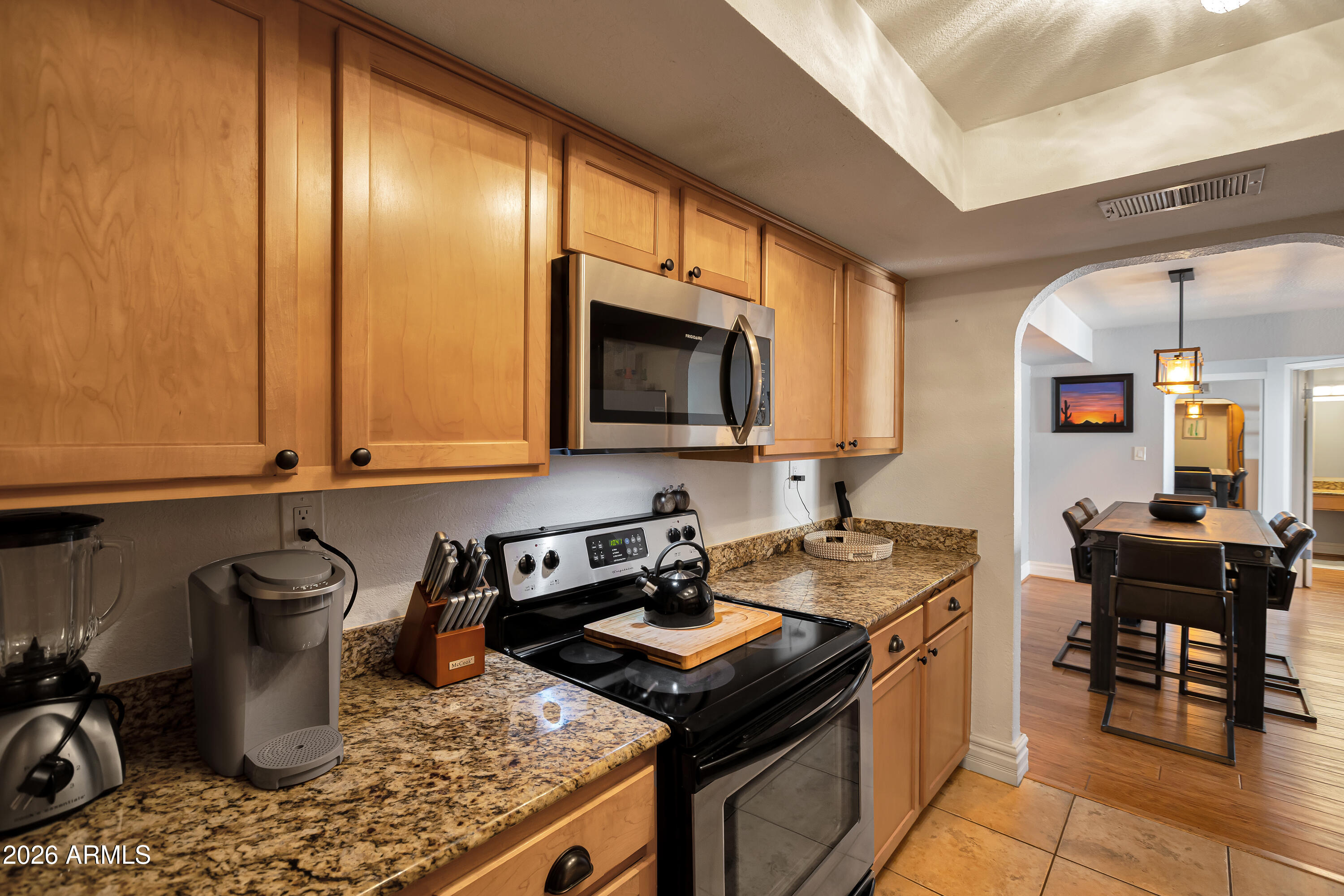3825 East Camelback Road, Unit 218 Phoenix, AZ 85018 - Photo 13 of 28 a kitchen with a stove and a microwave