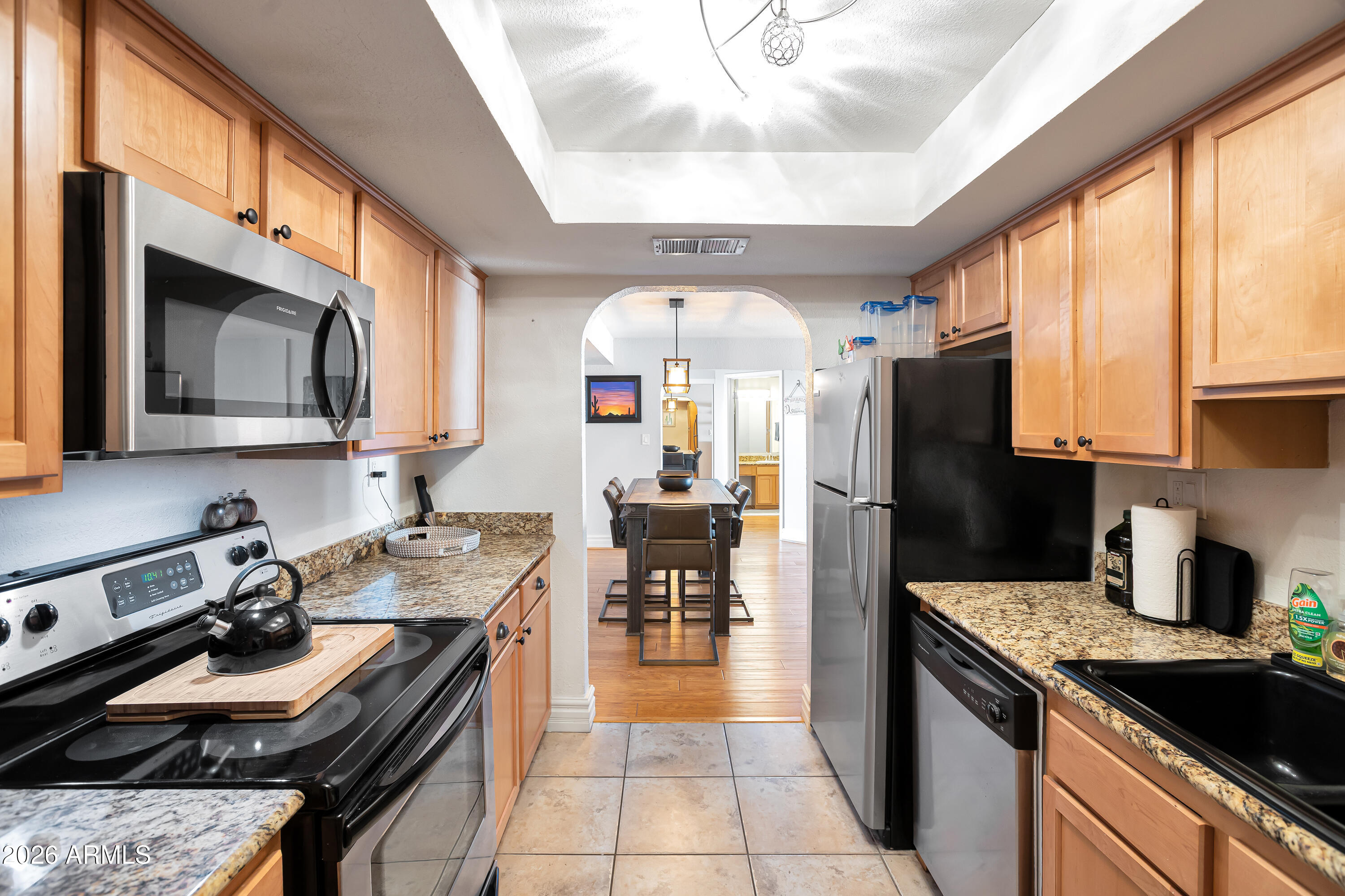 3825 East Camelback Road, Unit 218 Phoenix, AZ 85018 - Photo 14 of 28 a kitchen that has a lot of cabinets in it and appliances