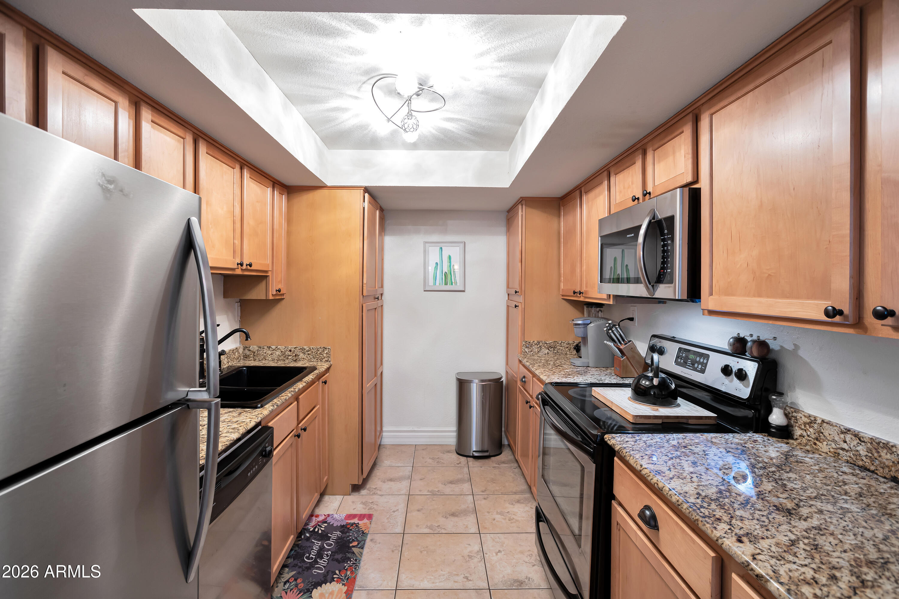 3825 East Camelback Road, Unit 218 Phoenix, AZ 85018 - Photo 15 of 28 a kitchen with a stove a sink and a refrigerator