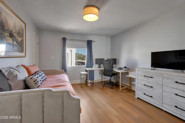 a bedroom with furniture and flat screen tv