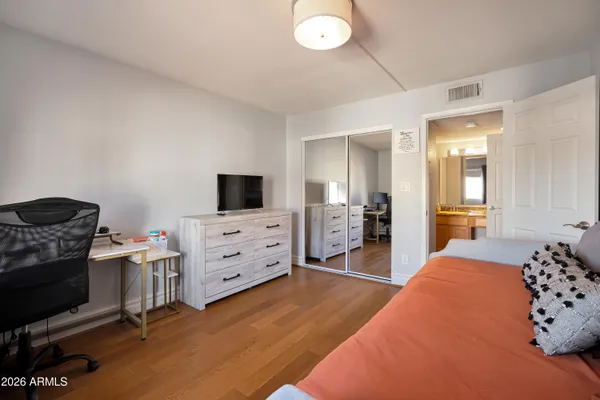 a bathroom with a granite countertop sink and a toilet