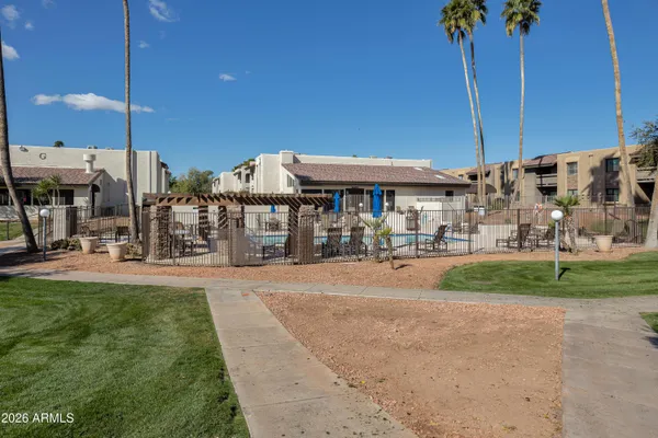 a view of a brick wall and a flower garden