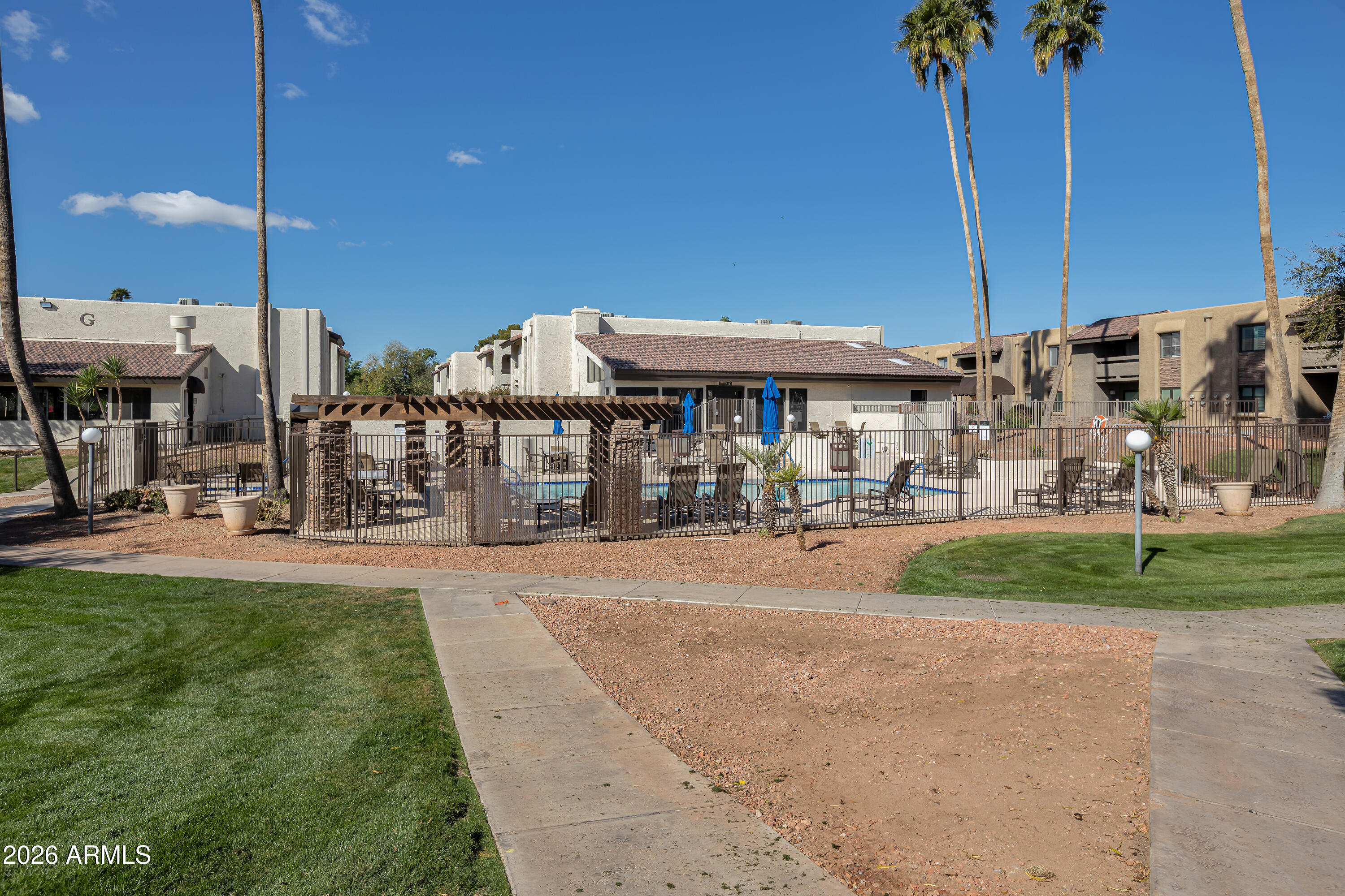 3825 East Camelback Road, Unit 218 Phoenix, AZ 85018 - Photo 22 of 28 a front view of a building with a garden