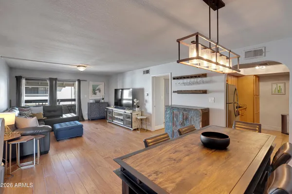 a living room with furniture and a wooden floor