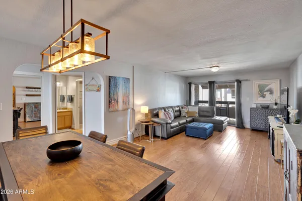a living room with furniture and a wooden floor