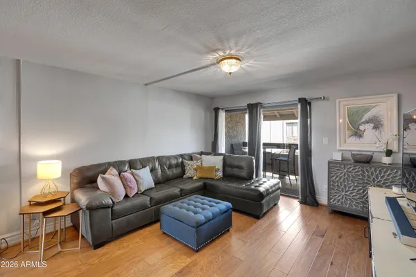 a living room with furniture and wooden floor