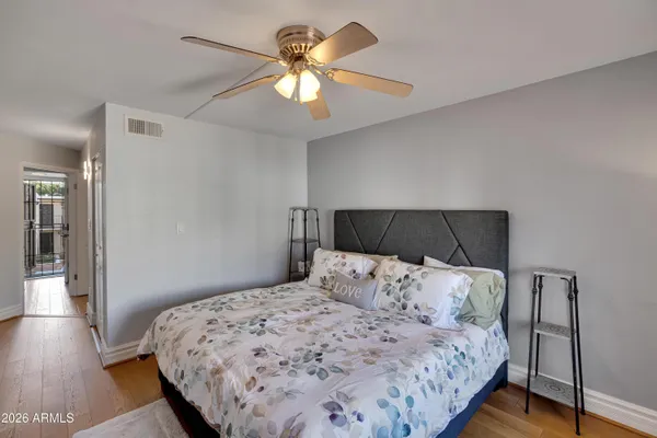 a room with stainless steel appliances kitchen island granite countertop furniture and a refrigerator