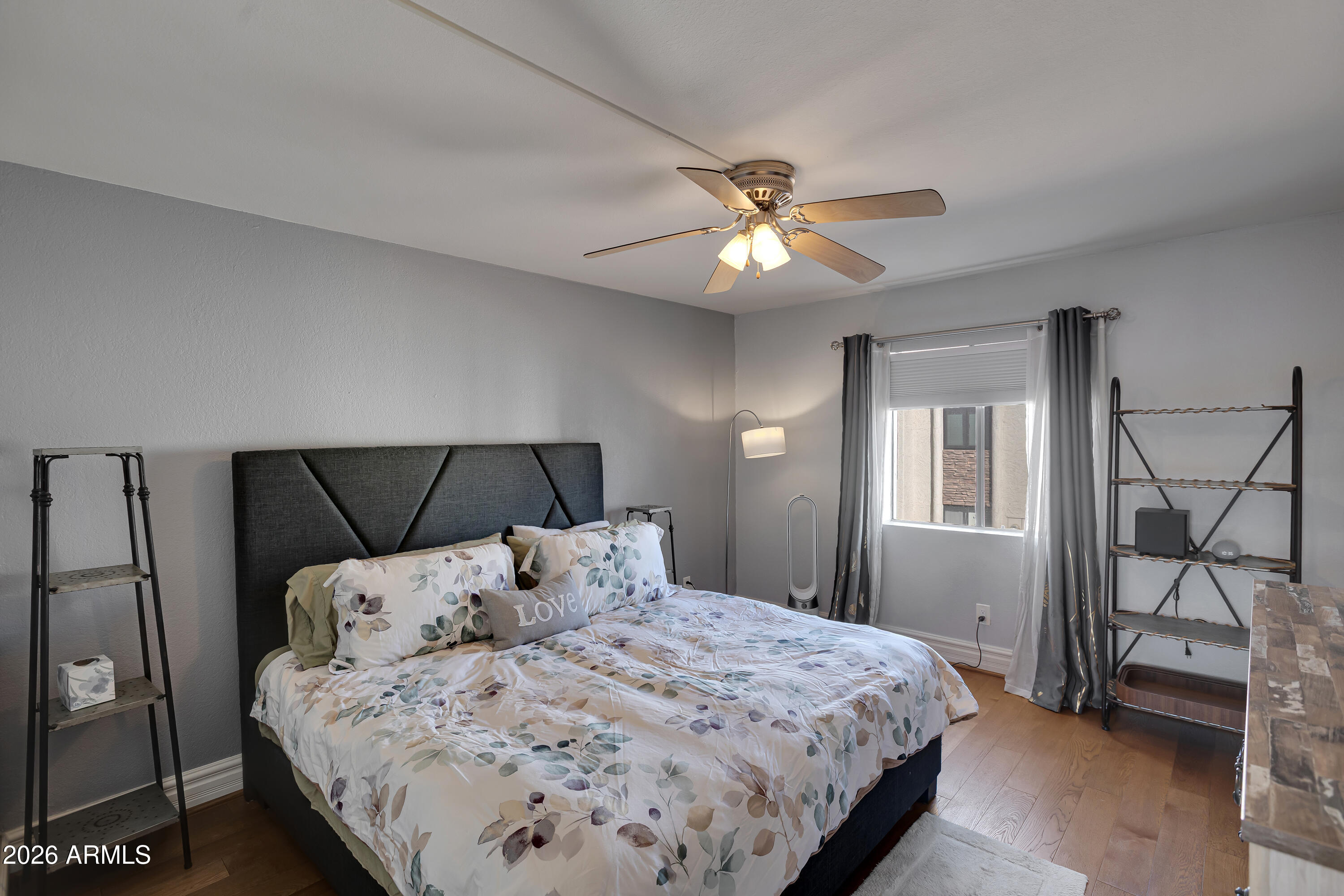 3825 East Camelback Road, Unit 218 Phoenix, AZ 85018 - Photo 7 of 28 a bedroom with a bed and a chandelier