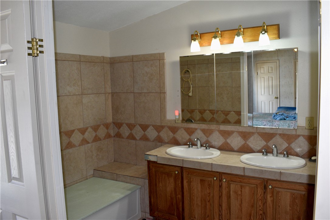 25051 Lake Shore Drive Mathis, TX 78368 - Photo 35 of 40 a bathroom with a sink and a mirror