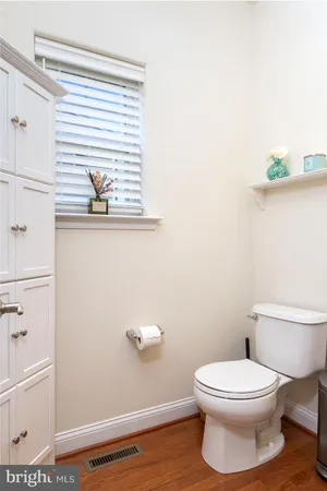 a white toilet sitting next to a bathroom sink