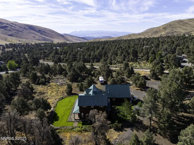 a view of a big house with a mountain in the background