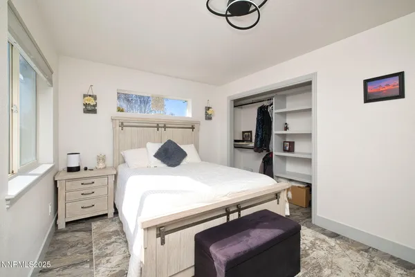 a bedroom with a bed and a table