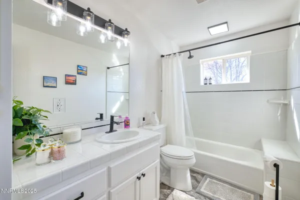 a bathroom with a sink a large mirror and a shower