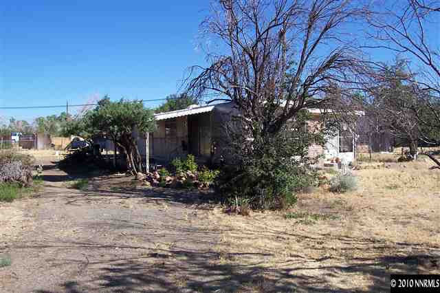 375 Zolezzi Lane Reno, NV 89511 - Photo 1 of 9 a view of a yard covered with snow on the roadside